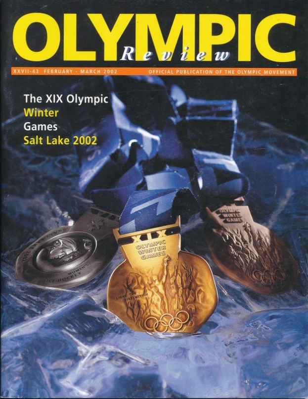 Buchumschlag mit der Aufschrift "Olympische Zeitschrift" und mehreren Medaillen in verschiedenen Größen und Farben sowie fetter Schrift.