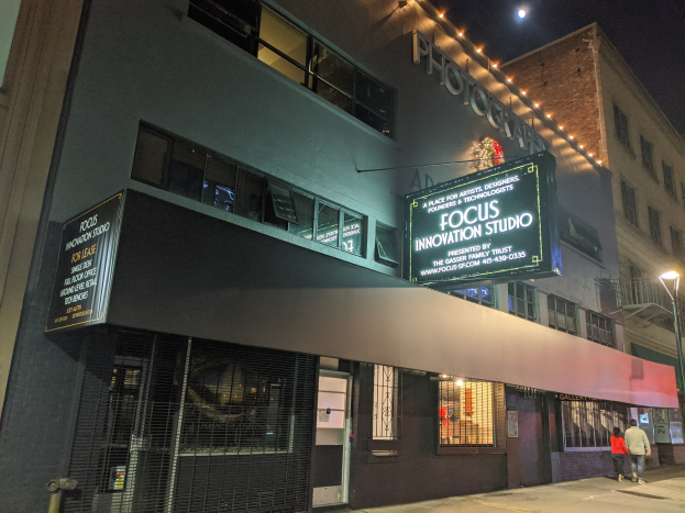 Außenansicht des Focus Innovation Studio in New York City bei Nacht, mit Menschen auf dem Bürgersteig und Gebäuden im Hintergrund.