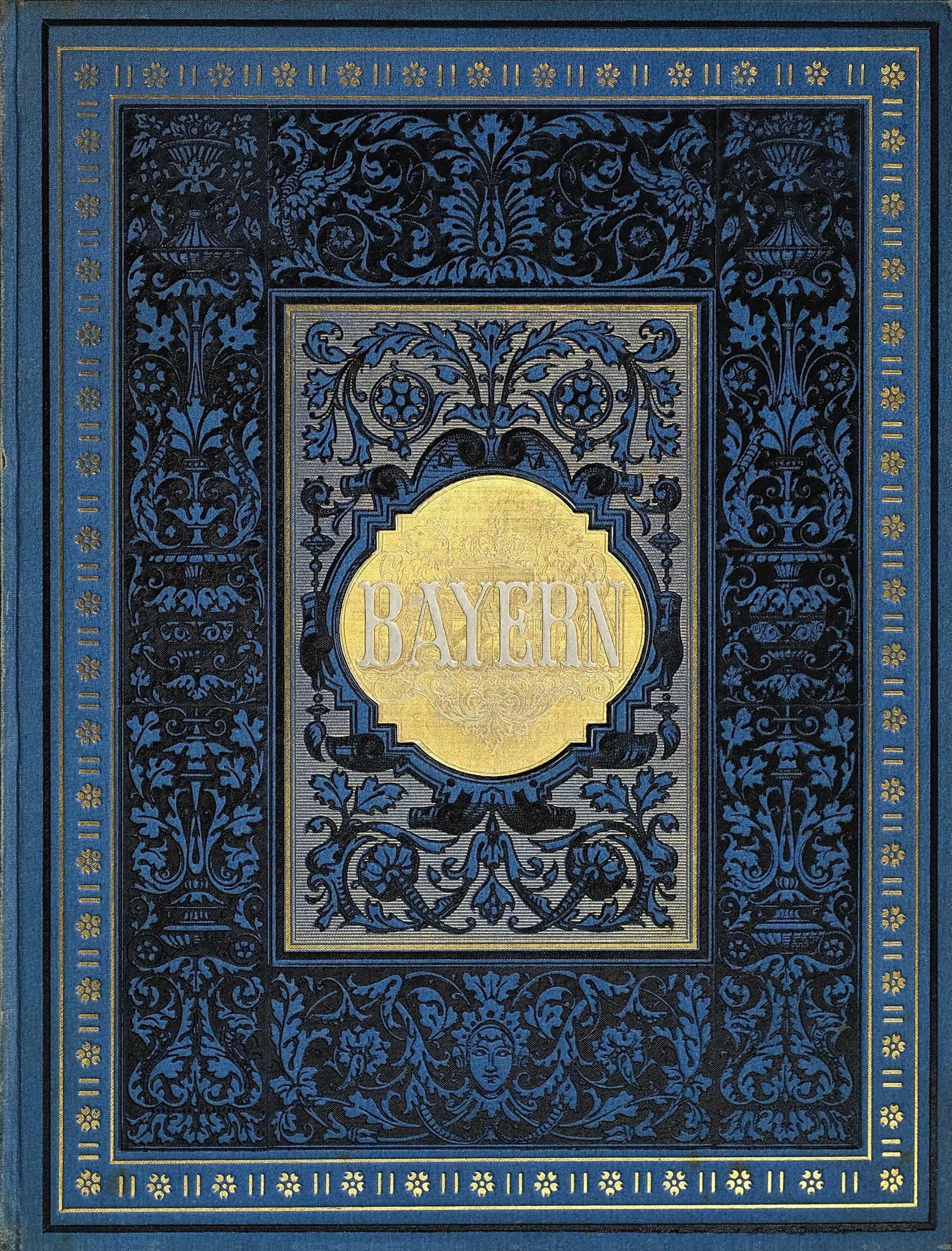 Blau-goldenes Buch mit "Bayern" darauf, verziert mit detailreichen Ornamenten.