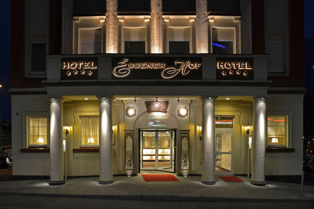 Das Essener Hof Hotel in Berlin, Deutschland, mit einer Straße und Fahrzeugen davor, unter einem sichtbaren Himmel.